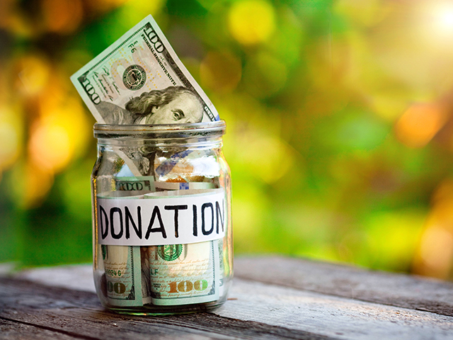 Mony in a jar with lable that says "DONATIONS" in all caps
