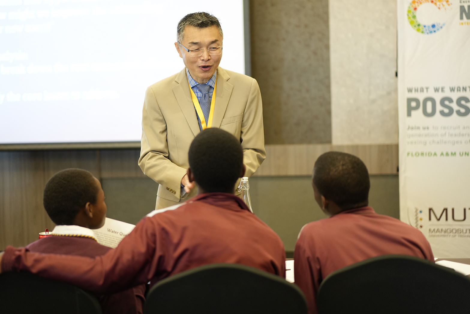 Professor Gang Chen interacts with Why Hack participants. (Credit:Ernest Nelfrard)