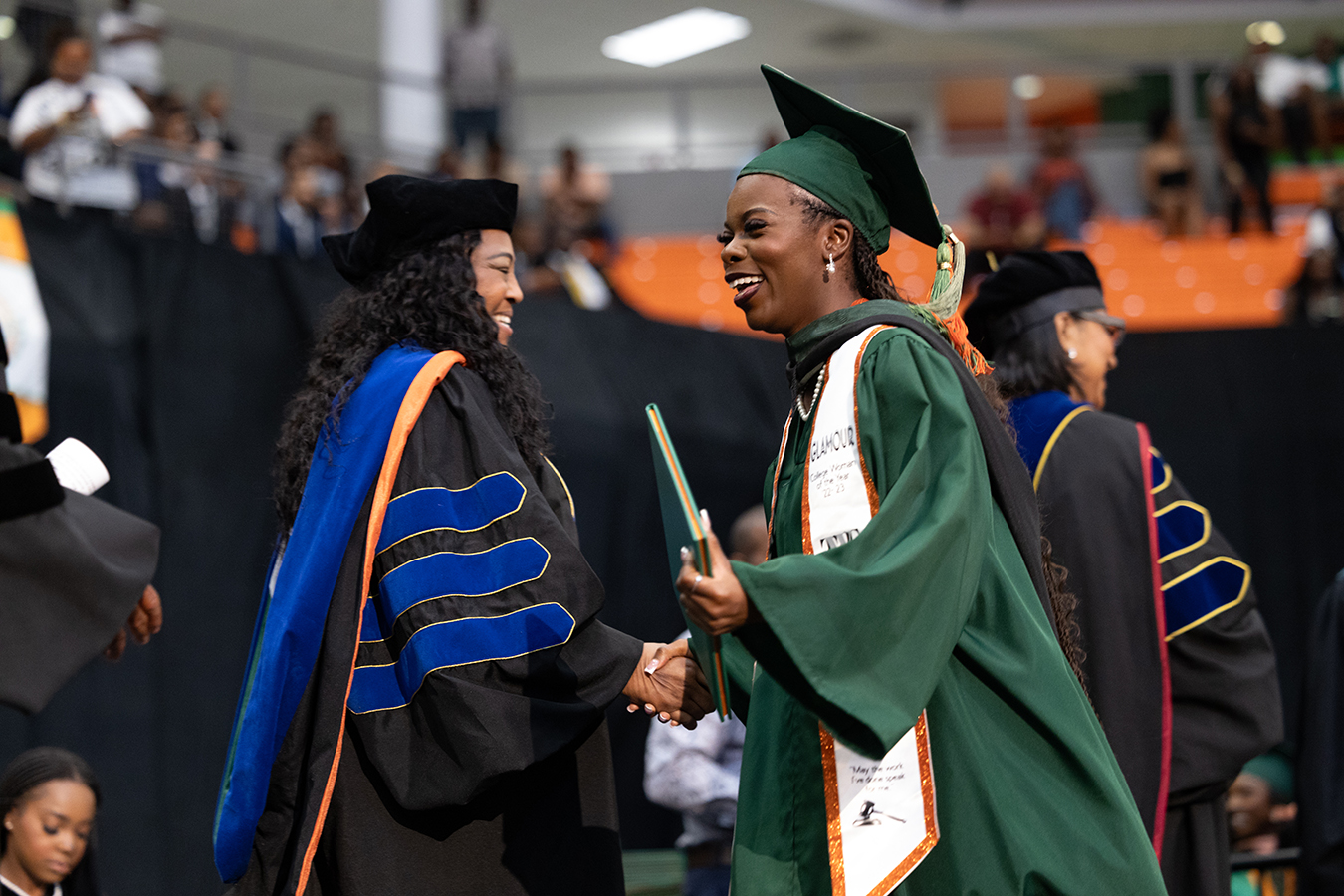 Dean Mary Simmons congratulates a graduate during the spring 2024 Commencement ceremony. (Credit: Christian J. Whitaker)