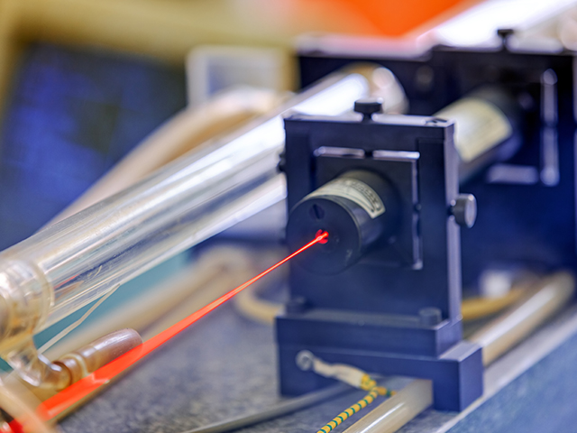 Laser Safety Program Red laser on optical table in physics laboratory