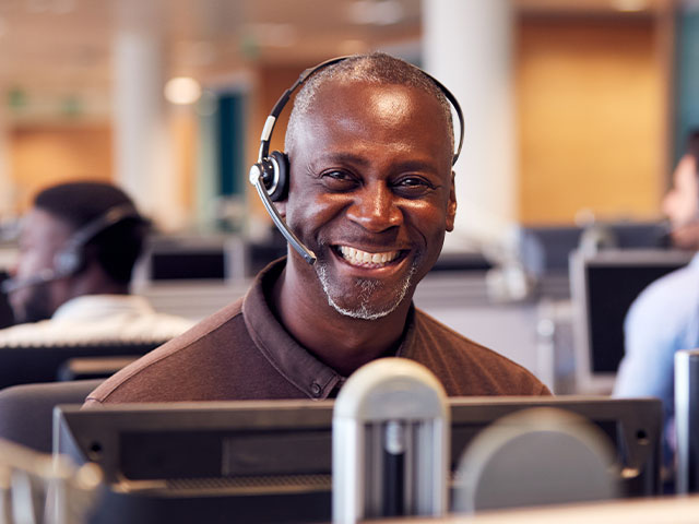 IT worker with headset smiling