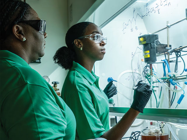 Arnett with student in lab