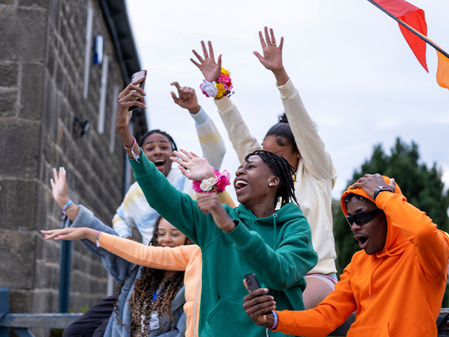 Group of happy students outside taking a selfie