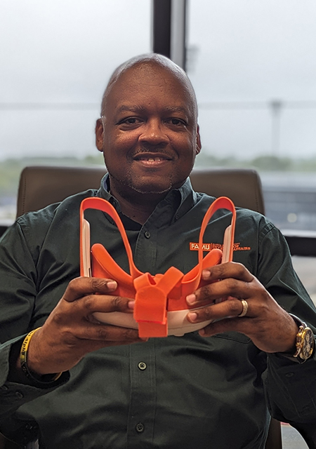 Dr. William Hudson, Jr. VP, Florida A&M University Student Affairs, Holding an orange set of VR equipment
