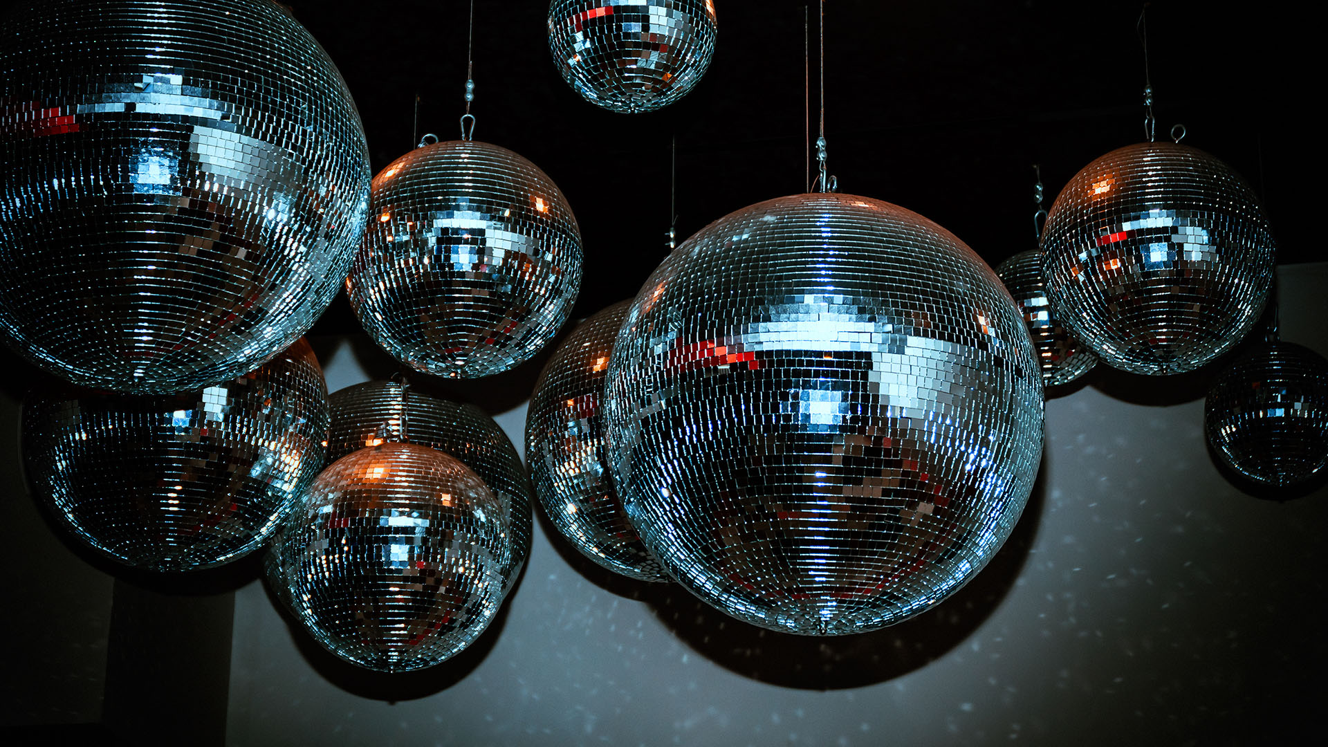 Disco balls hanging from ceiling in a nightclub room