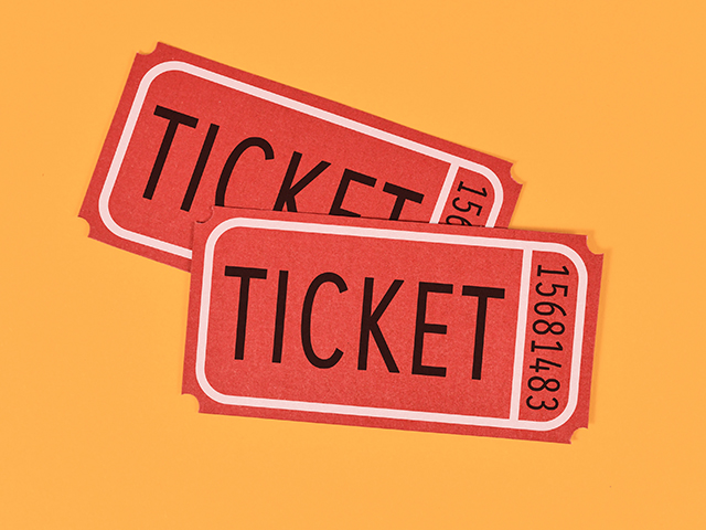 Two old fashioned red tickets on yellow background